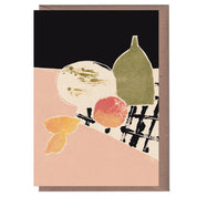 Greeting card with a linocut print design featuring abstract elements, including a shape resembling a melon, an apple, and a bottle, in a combination of black, beige, green, and red colors.