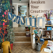 Interior of a creative space with art supplies and motivational quote on the wall.