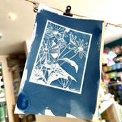 Blue floral print hanging on a wire in a store setting