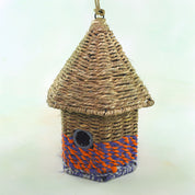Bird nester in grass and sari fabric, house shape