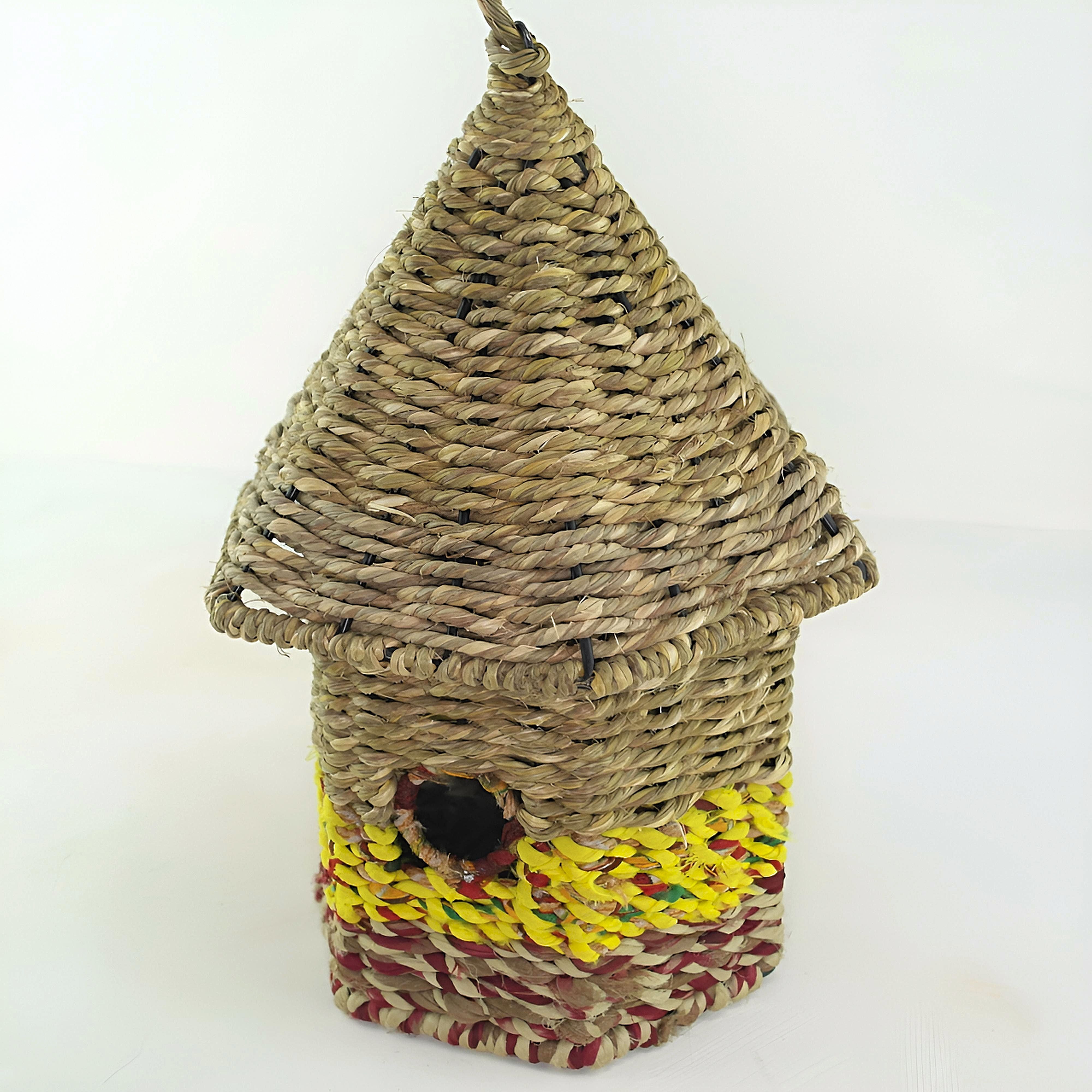 Bird nester in grass and sari fabric, house shape