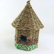 Bird nester in grass and sari fabric, house shape