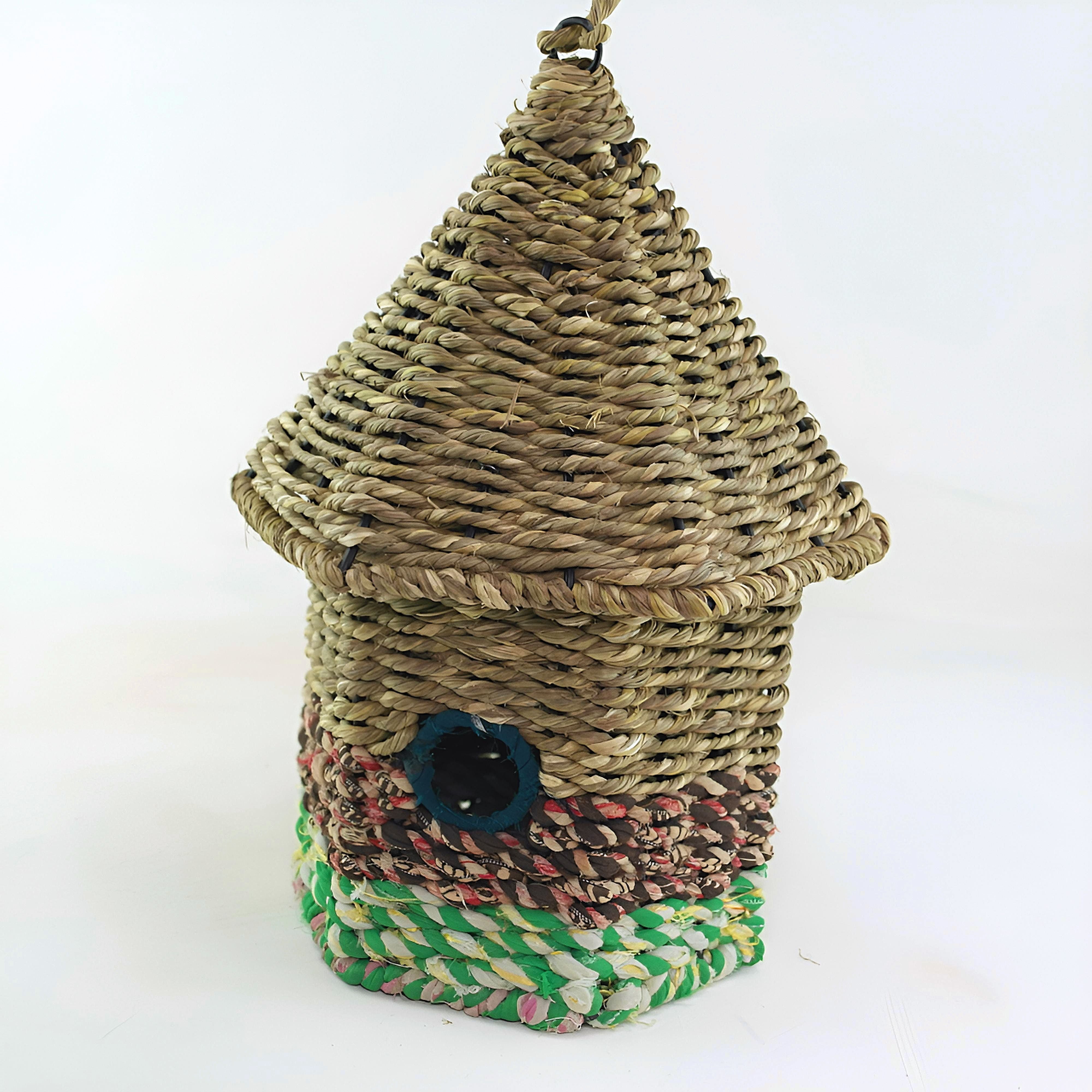 Bird nester in grass and sari fabric, house shape