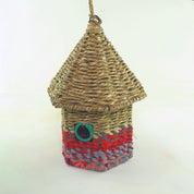 Bird nester in grass and sari fabric, house shape