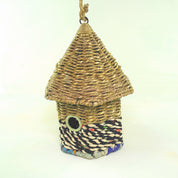Bird nester in grass and sari fabric, house shape