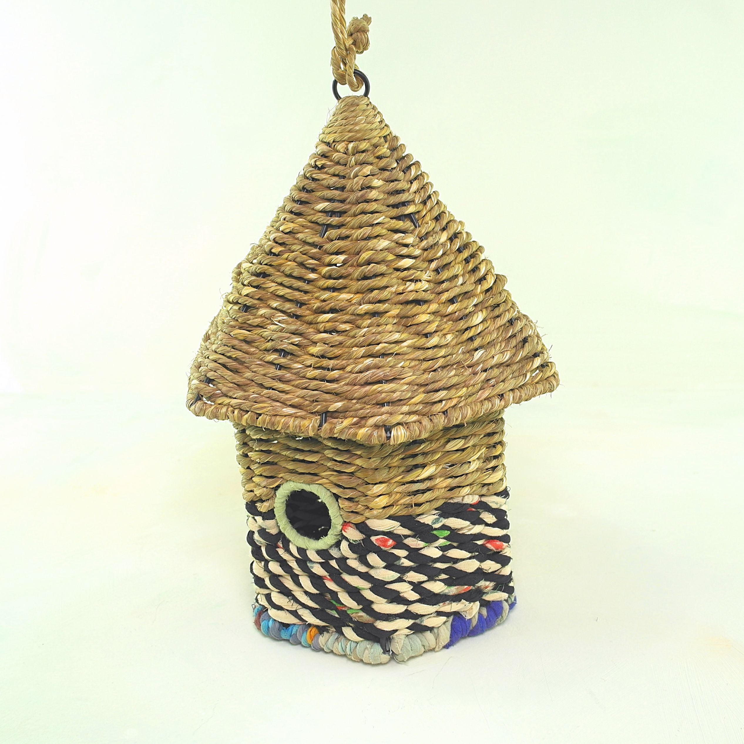 Bird nester in grass and sari fabric, house shape