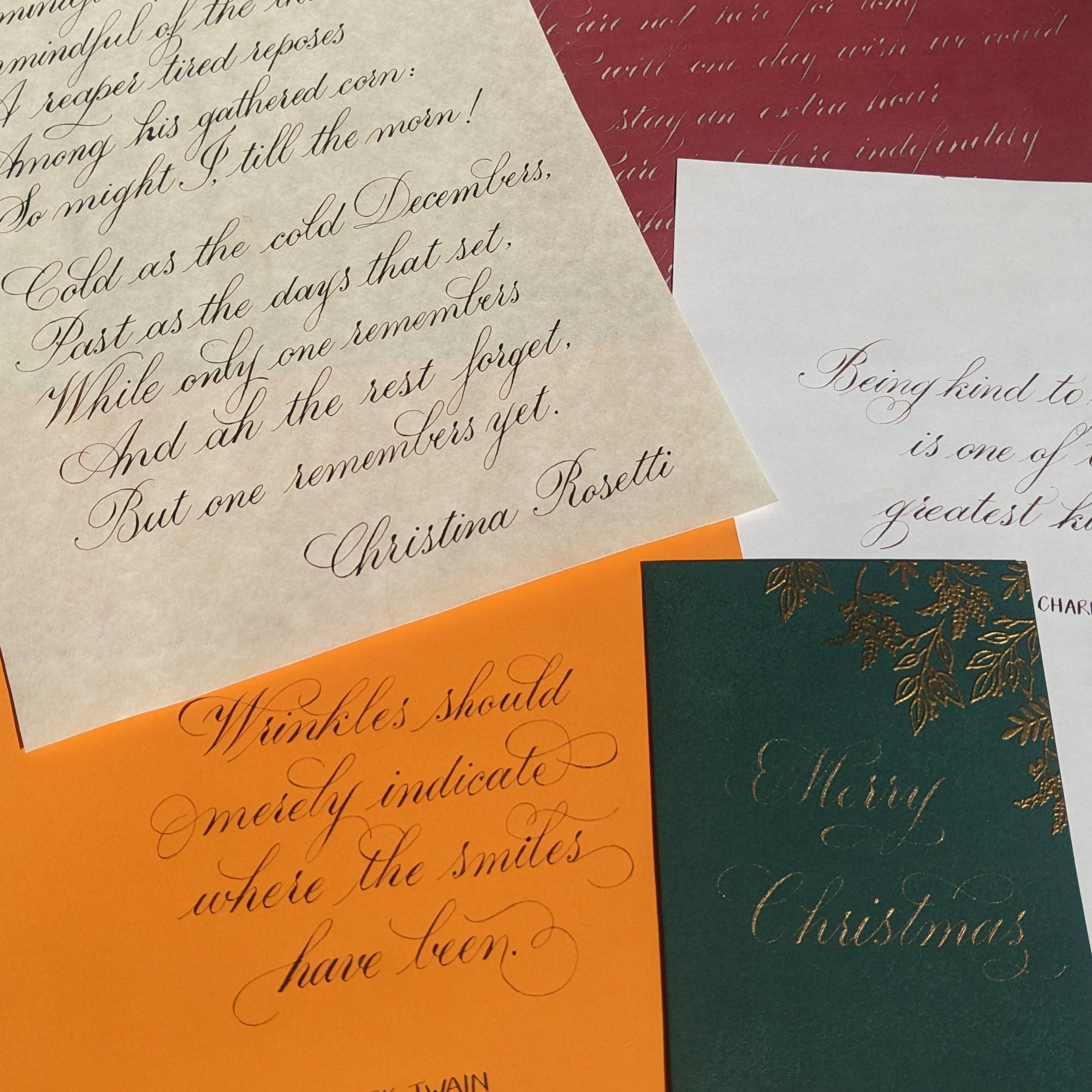 Collection of Christmas cards with handwritten text on a textured surface