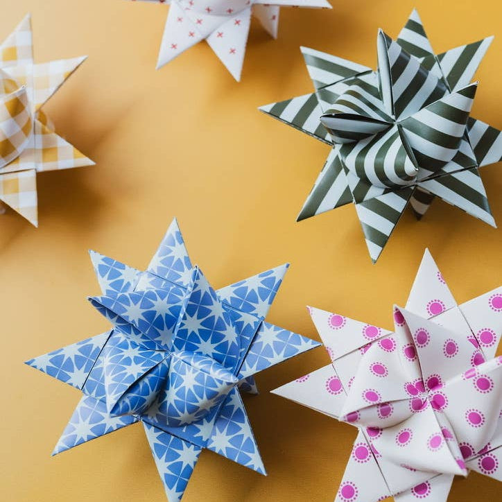 Paper stars with various patterns on a yellow background
