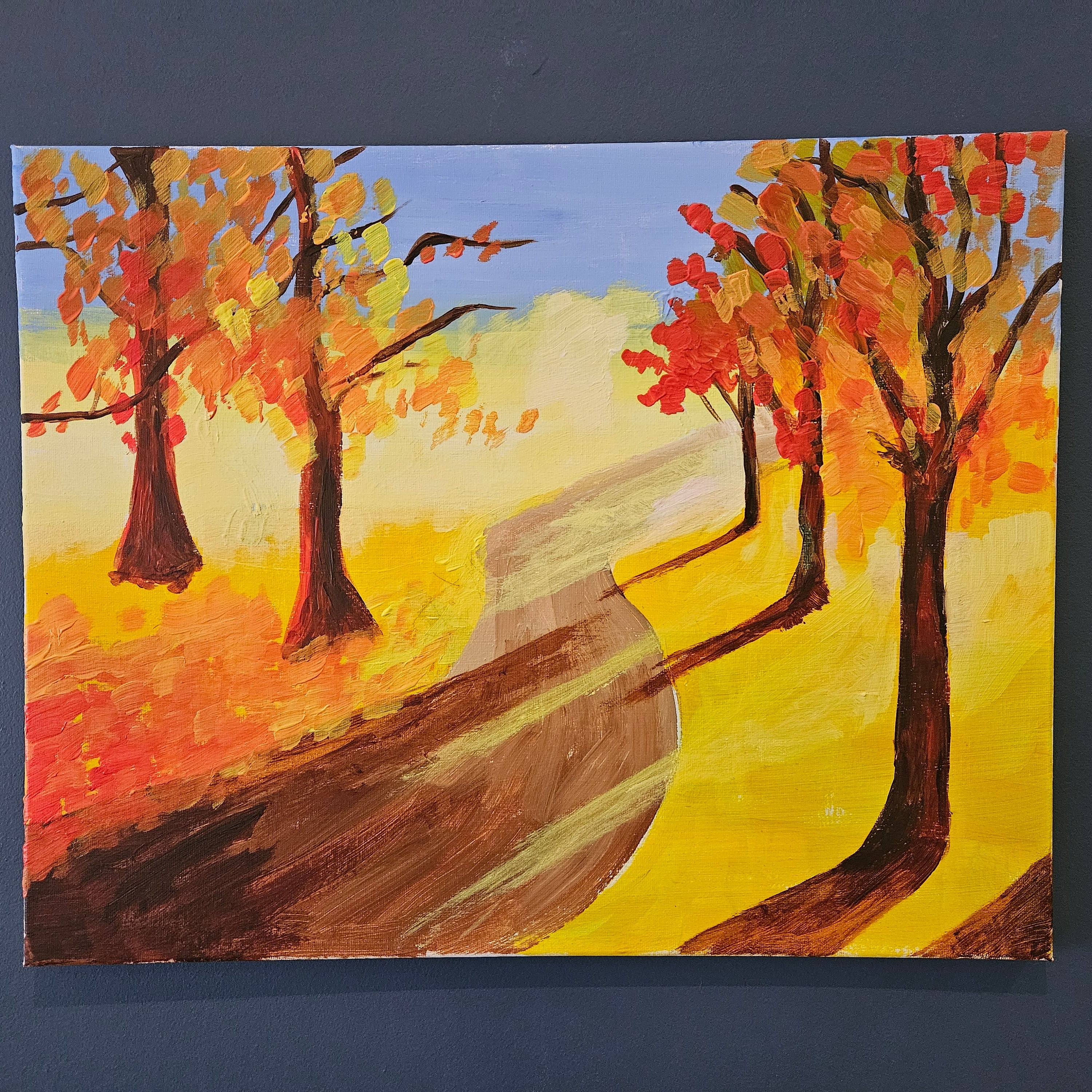 Painting of autumn trees with colorful leaves on a blue background