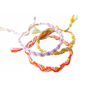 Set of colorful braided bracelets on a white background