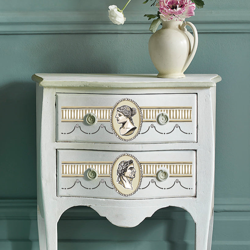 Vintage-style side table with decorative knobs against a teal wall