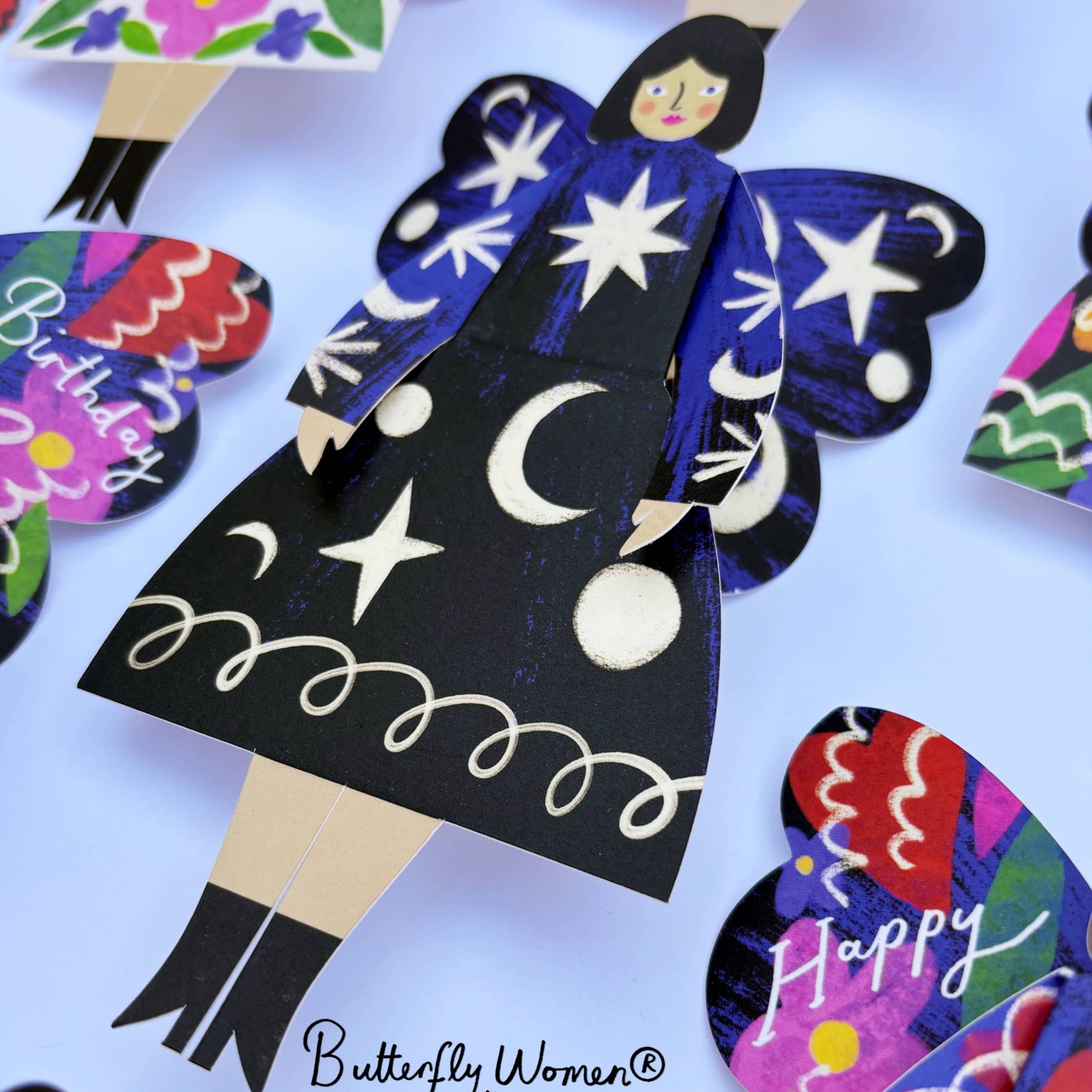 Colorful paper dolls with star and moon designs, featuring the Kitty Kenda brand.