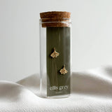 Gold-Plated Ginkgo Leaf Stud Earrings in glass vial