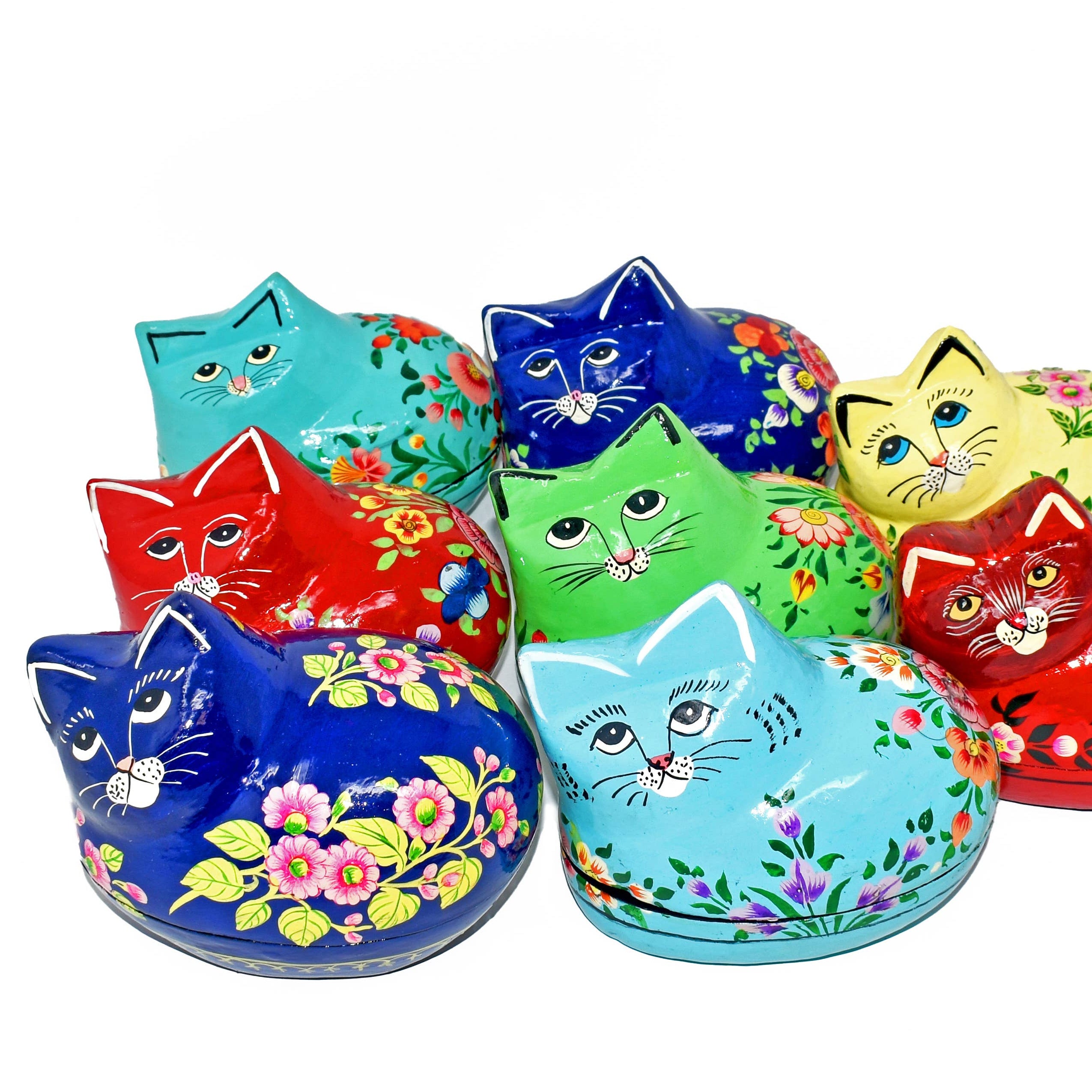 Colorful cat-shaped tin boxes with floral designs on a white background