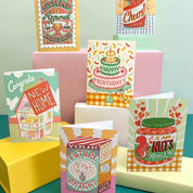 Collection of colorful greeting cards on a teal and yellow background