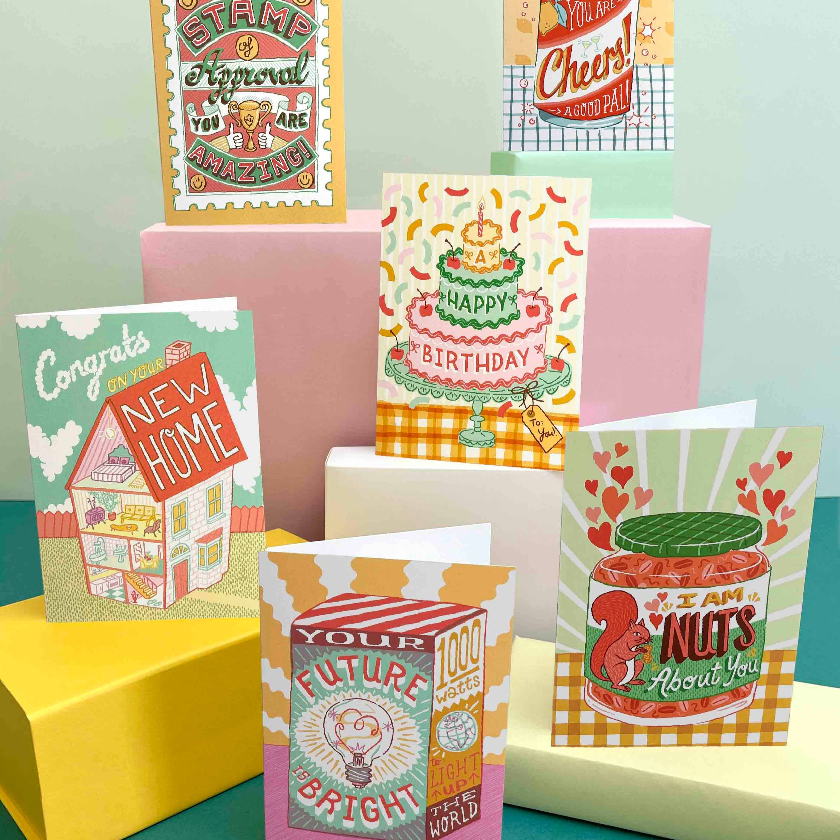 Collection of colorful greeting cards on a teal and yellow background