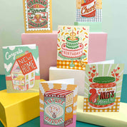 Collection of colorful greeting cards on a teal and yellow background