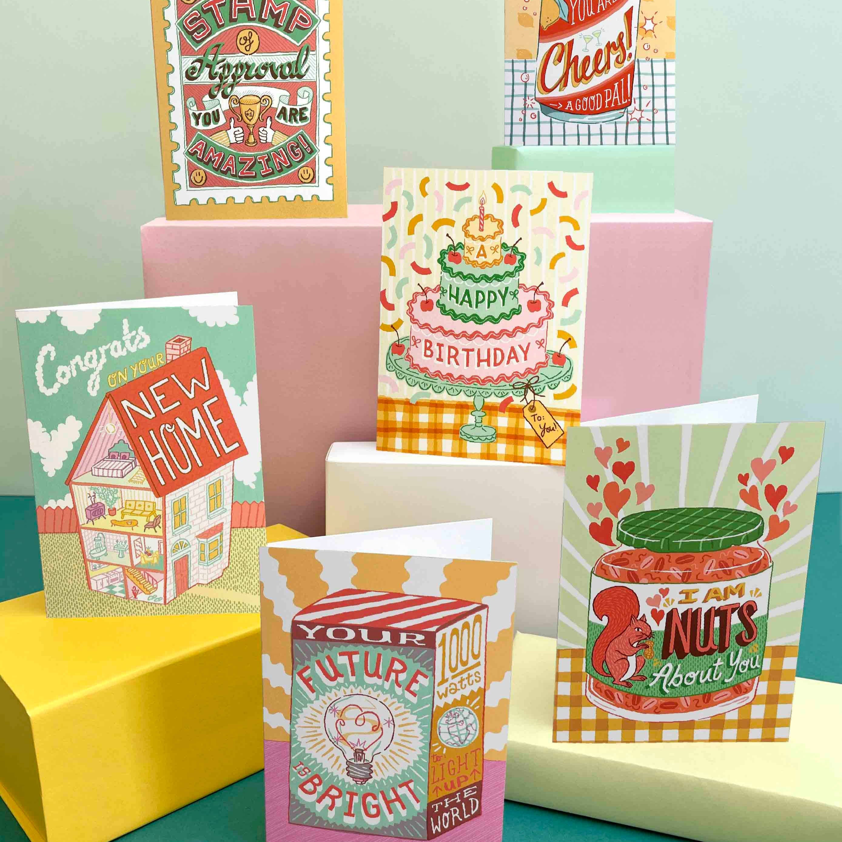 Collection of colorful greeting cards on a teal and yellow background