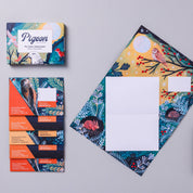 Colorful stationery set with envelopes and cards on a gray background
