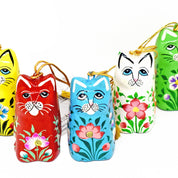 Set of colorful cat-shaped keychains with floral designs on a white background