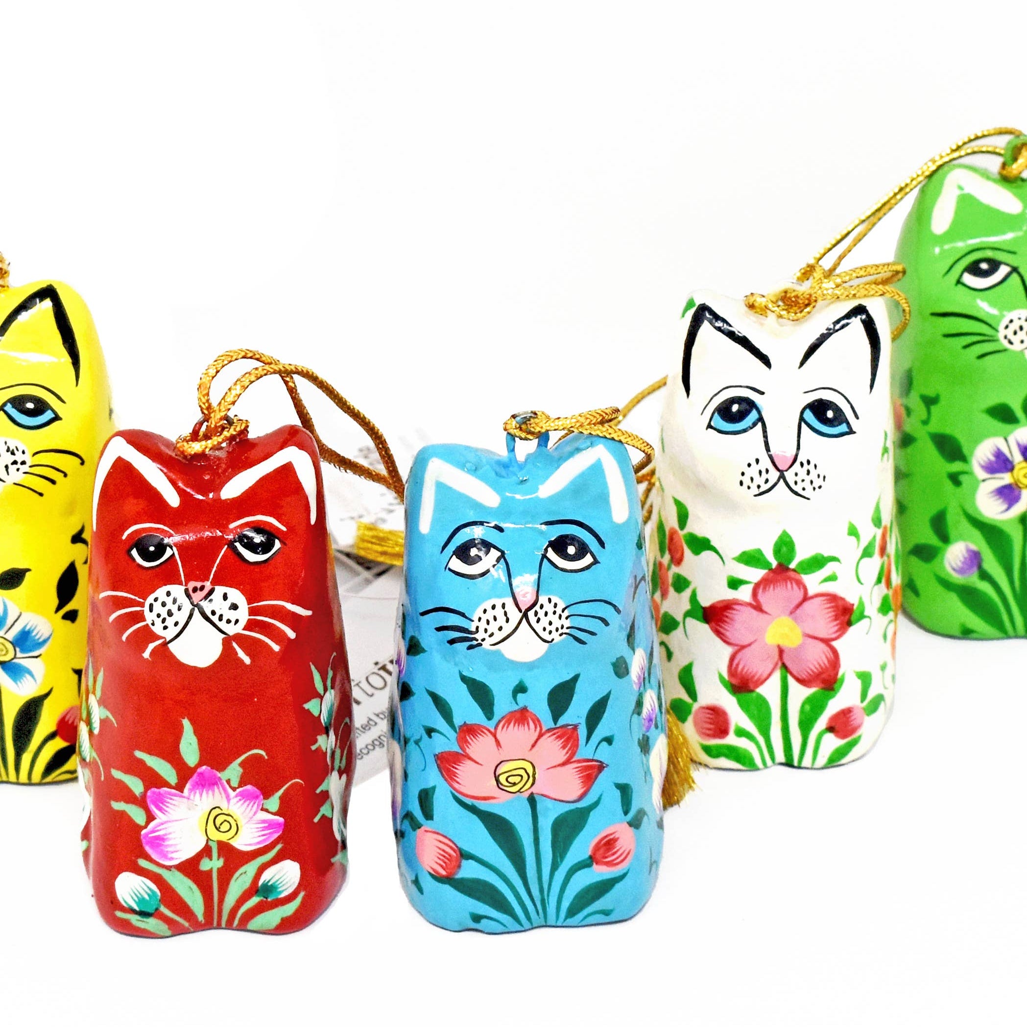 Set of colorful cat-shaped keychains with floral designs on a white background