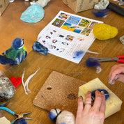 Crafting activity on a wooden table with various materials and tools.