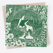 Greeting card with green and white illustration of women in a pond surrounded by nature on a beige envelope.