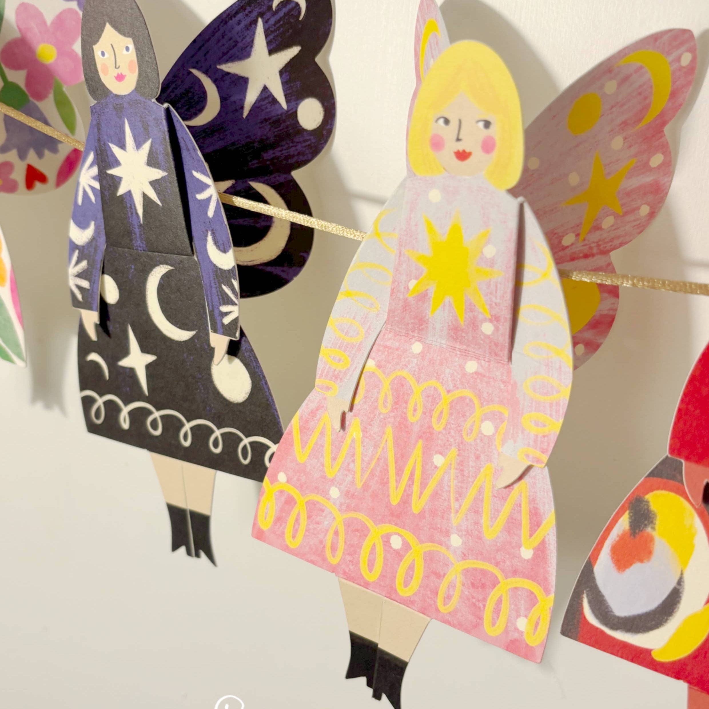 Colorful paper dolls with butterfly wings and dresses, featuring the brand 'Kitty Kenda'.