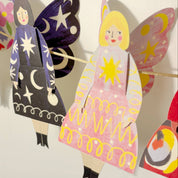 Colorful paper dolls with butterfly wings and dresses, featuring the brand 'Kitty Kenda'.