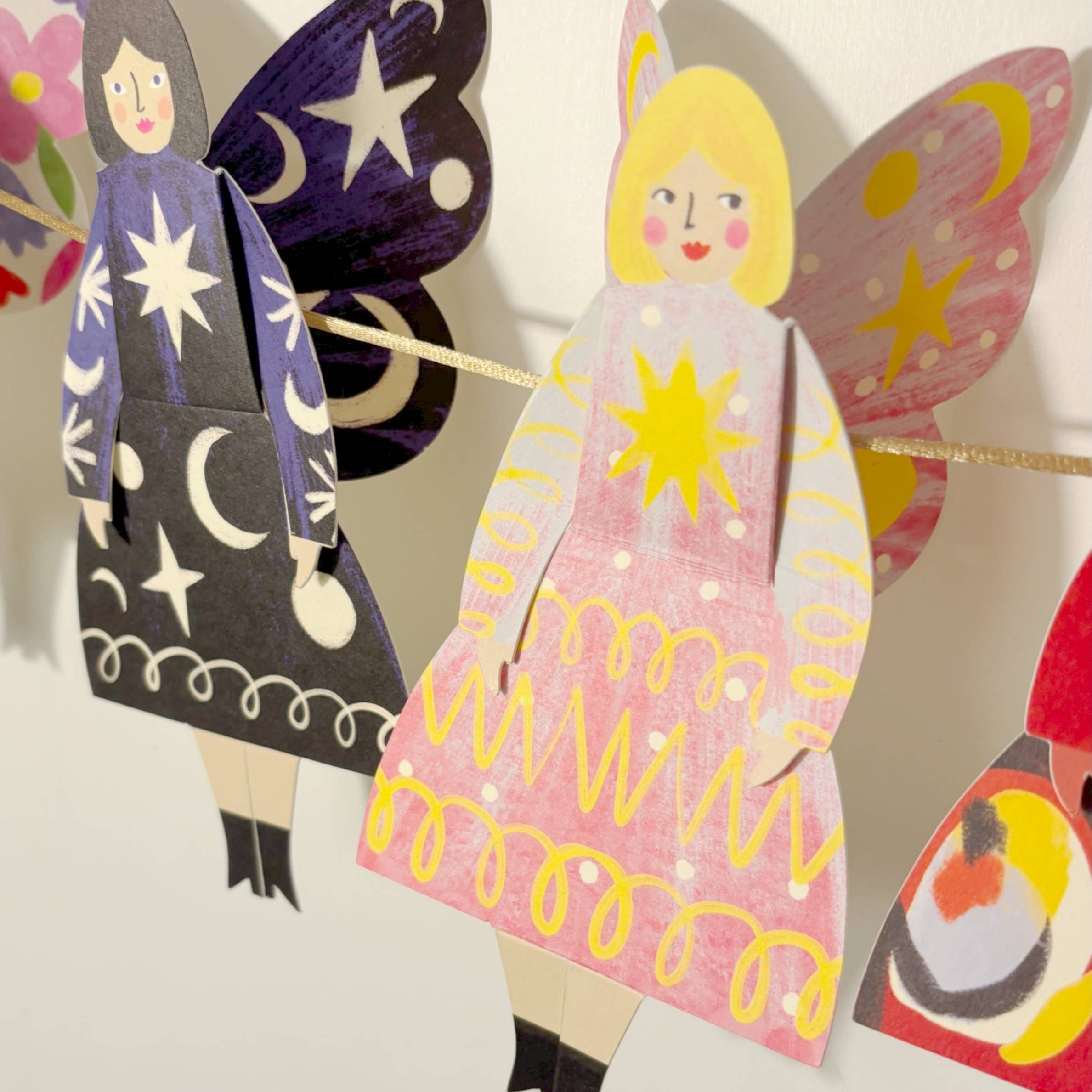 Colorful paper dolls with butterfly wings and dresses, featuring the brand 'Kitty Kenda'.