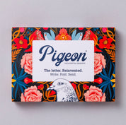 Pigeon product packaging with floral design and brand name on a gray background