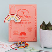 Embroidery kit with rainbow design on a light blue background