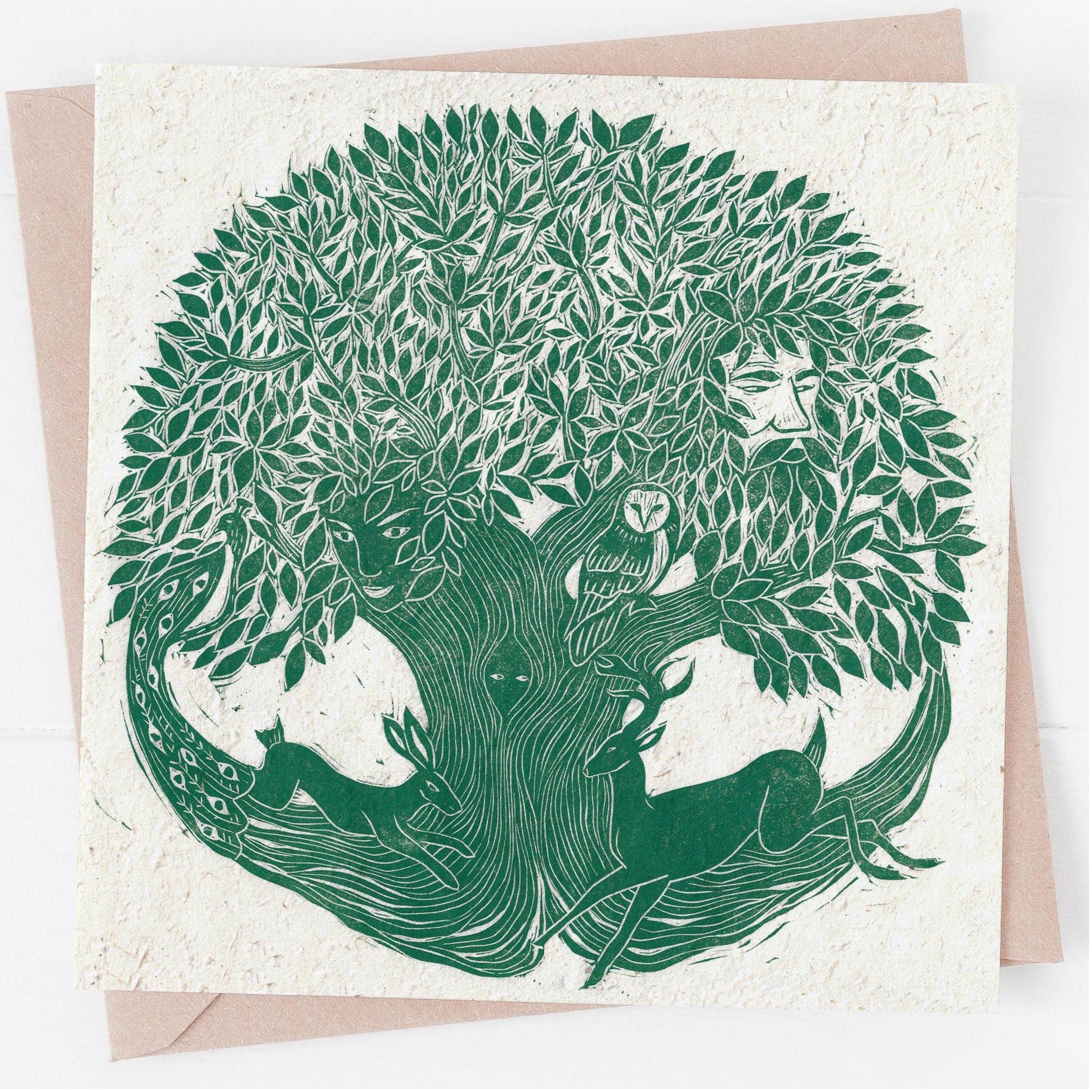 Greeting card with green tree and deer illustration on a white background