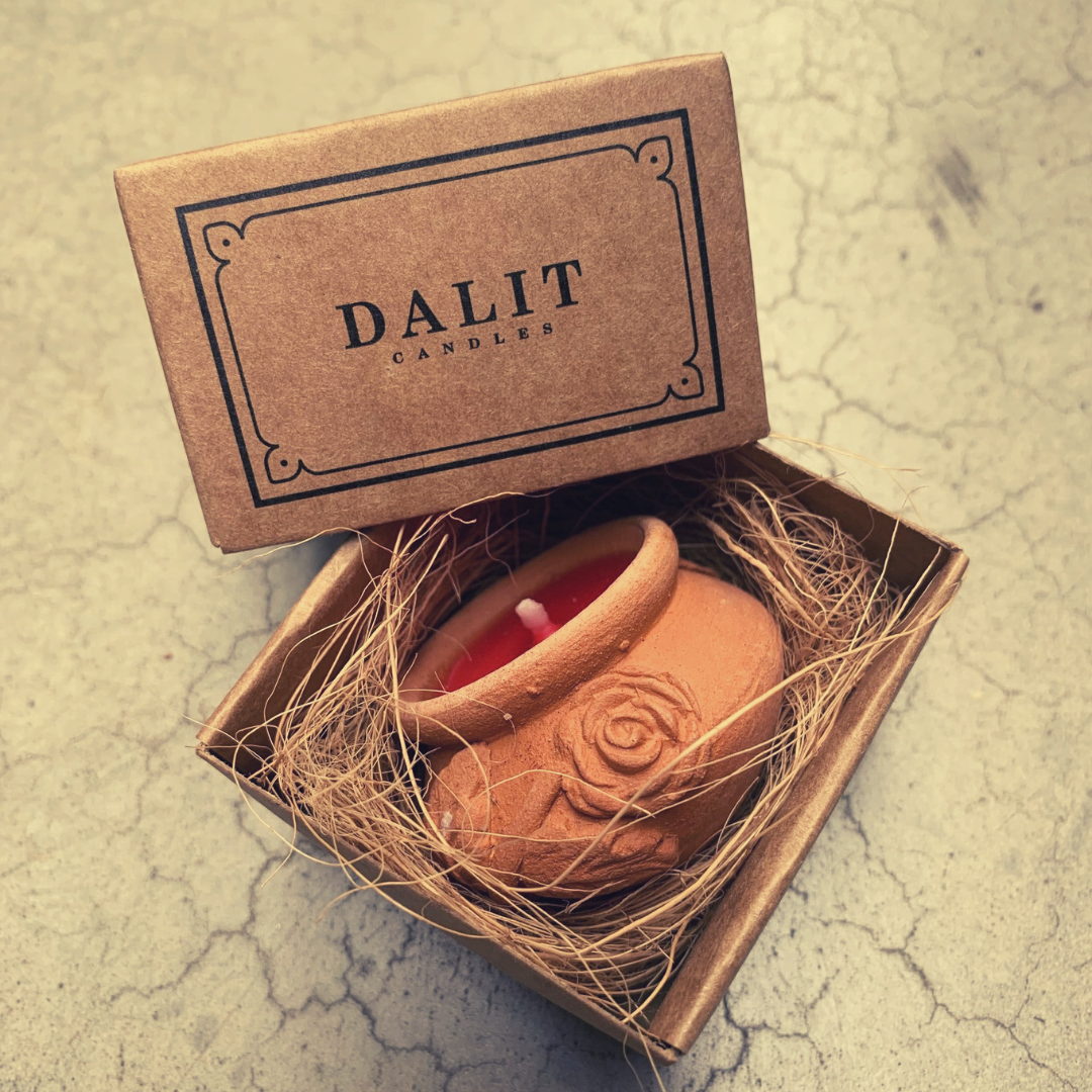 Candle in a decorative box with 'DALIT CANDLES' branding on a textured surface.