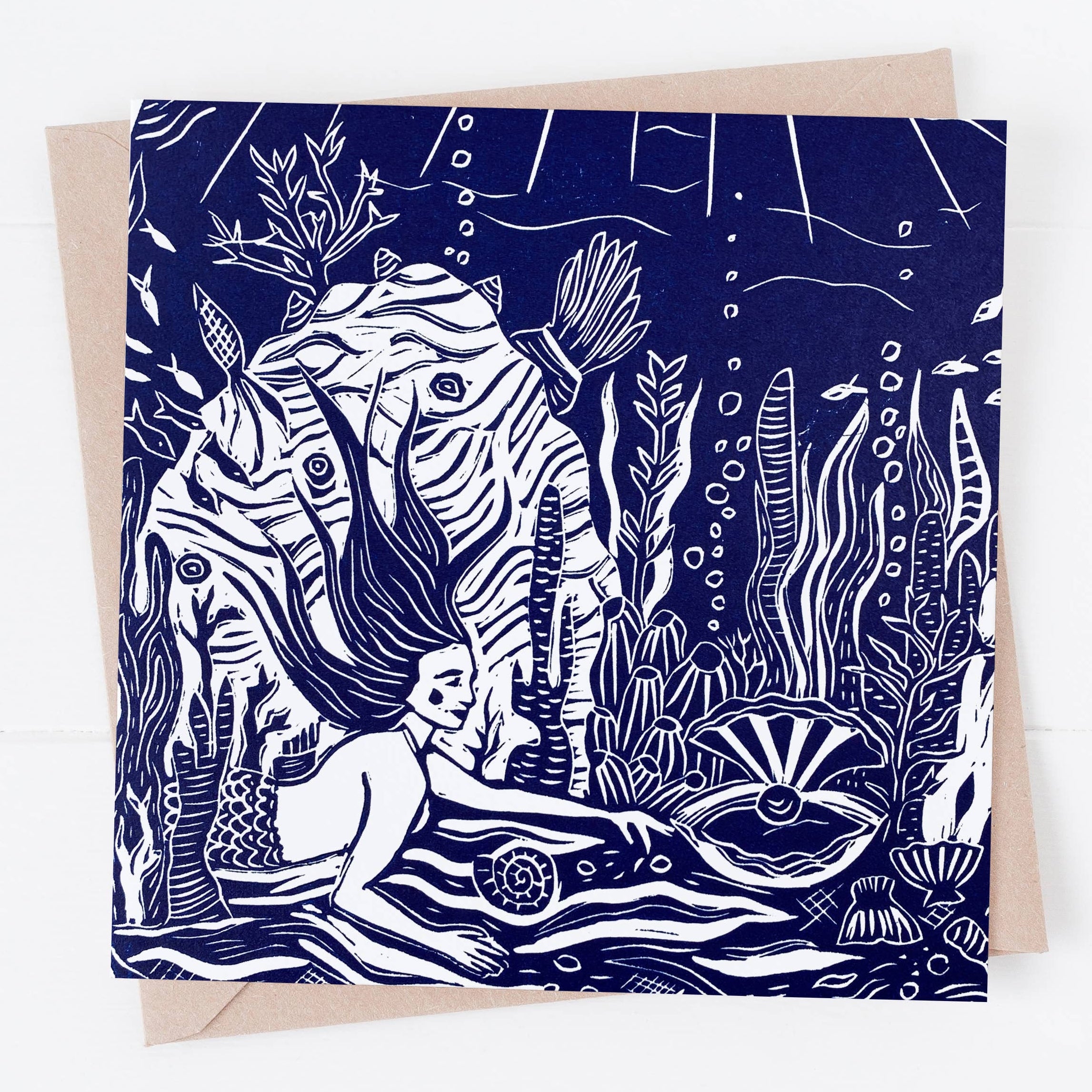 Greeting card with a zebra mermaid design on a blue background