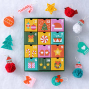 Colorful advent calendar with Christmas-themed decorations on a light gray background