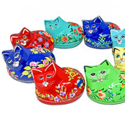Set of colorful cat-shaped tins with floral designs on a white background
