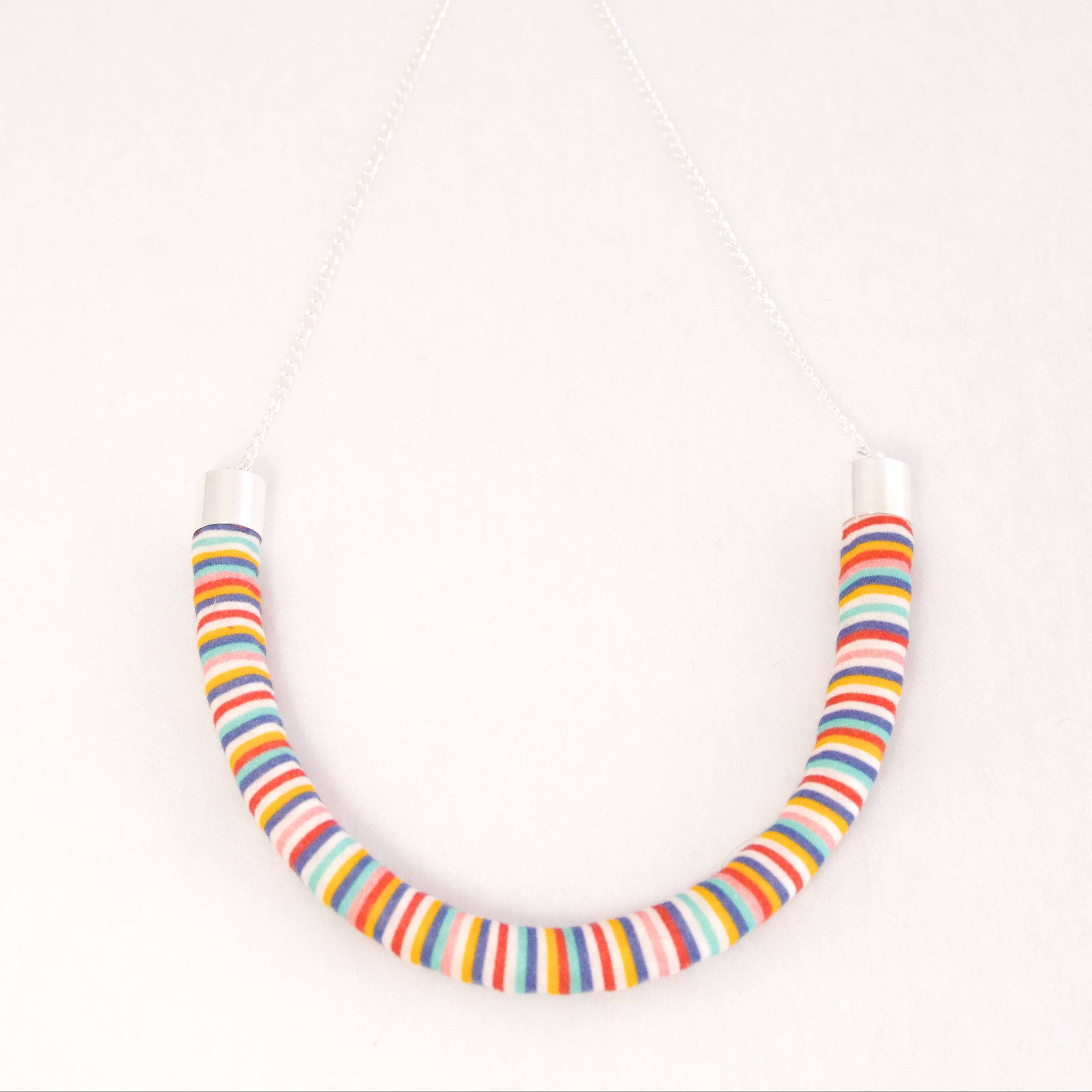 Colorful striped necklace on a white background