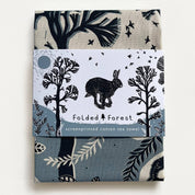 Cotton tea towel with forest design and rabbit illustration on a white background