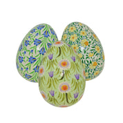 Three floral-patterned eggs on a white background