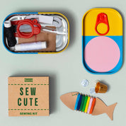 Sew Cute sewing kit with colorful components on a light gray background