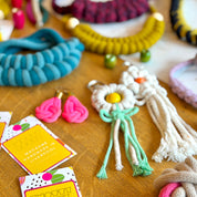 Colorful handmade dog toys and packaging on a wooden surface