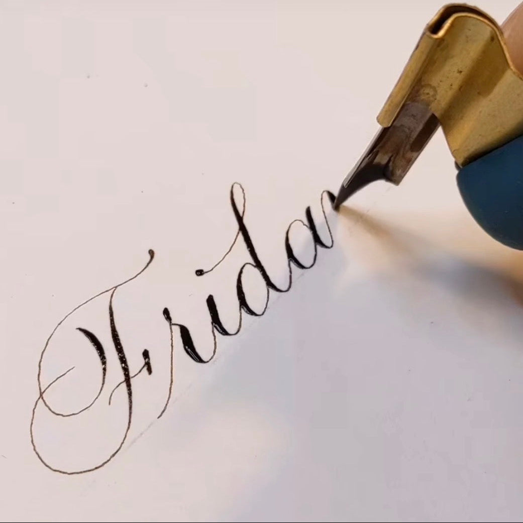 Fountain pen writing the word 'Friday' on a light background