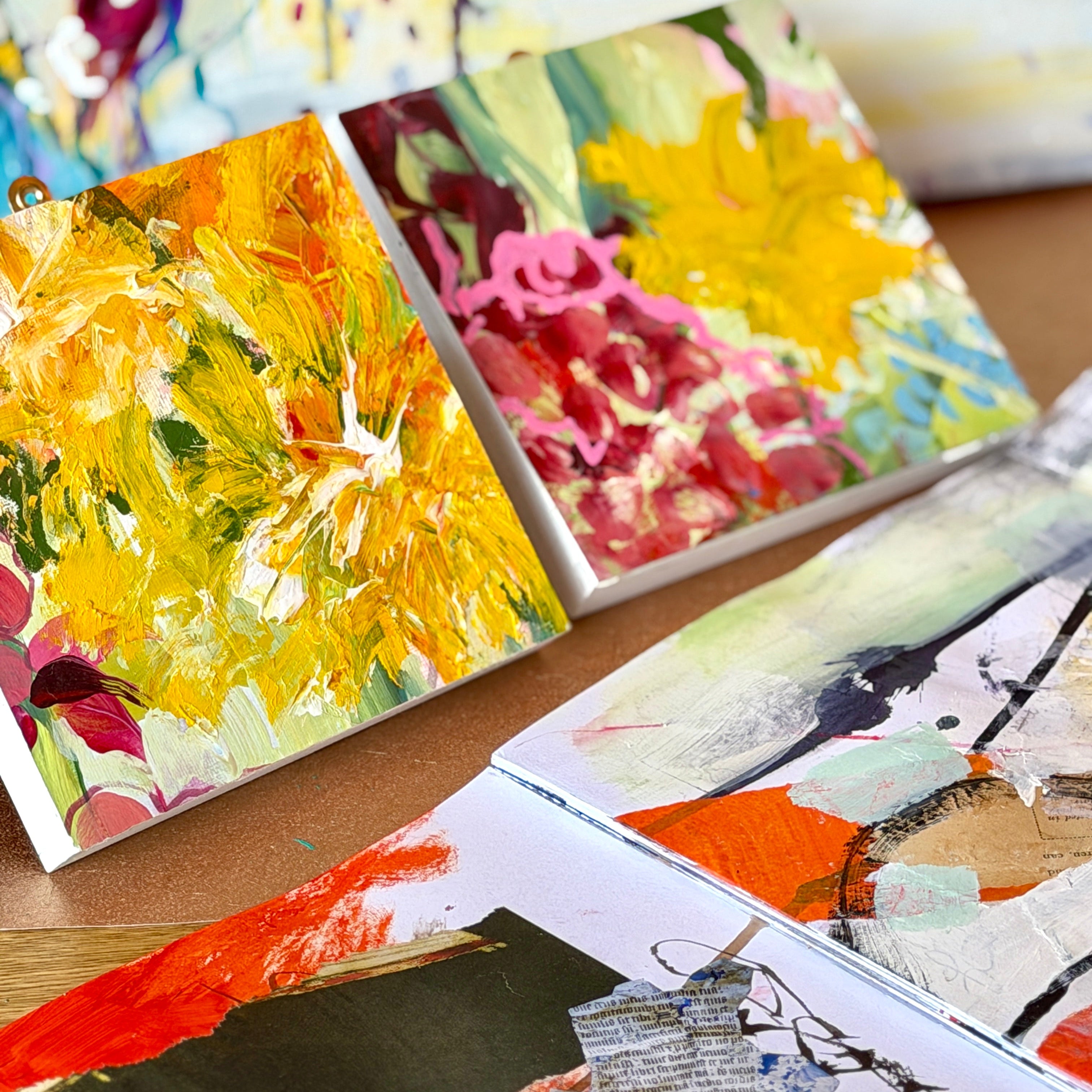 Colorful abstract paintings on a wooden surface