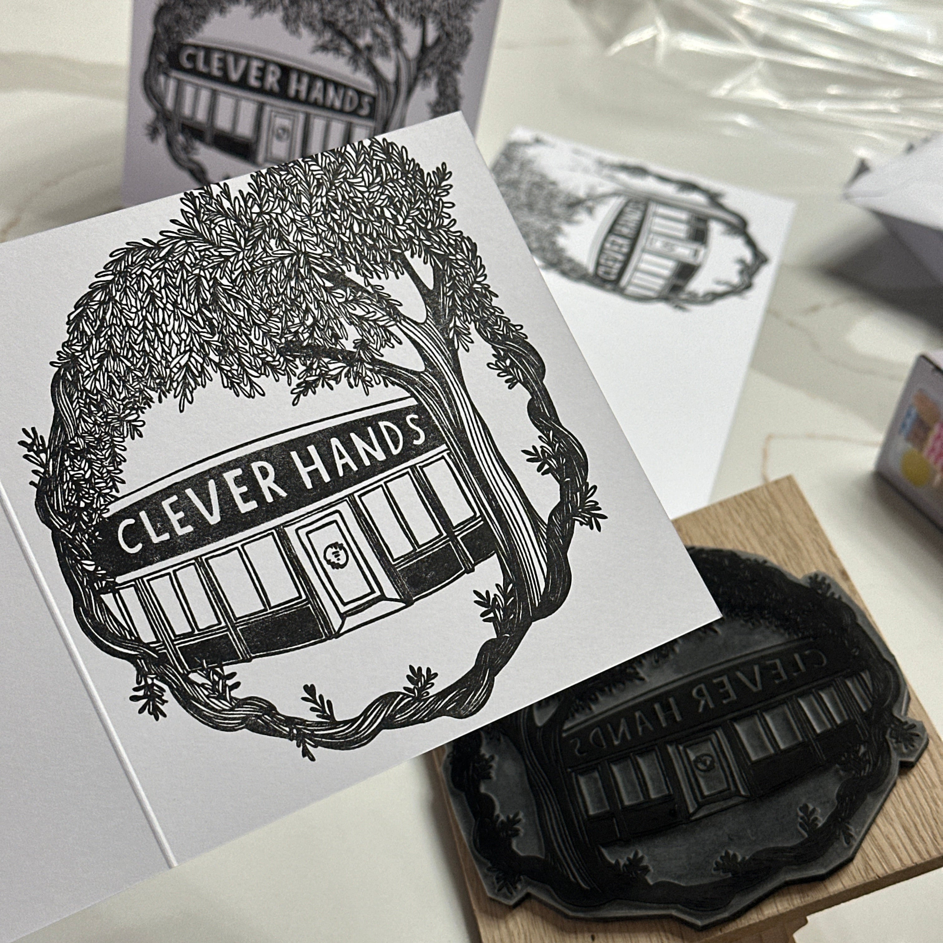Black and white stamp with 'Clever Hands' design on a white surface