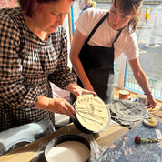 Two women working with clay in a pottery studio.