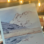 Close-up of a textured fabric swatch held by a hand with a blurred indoor background.