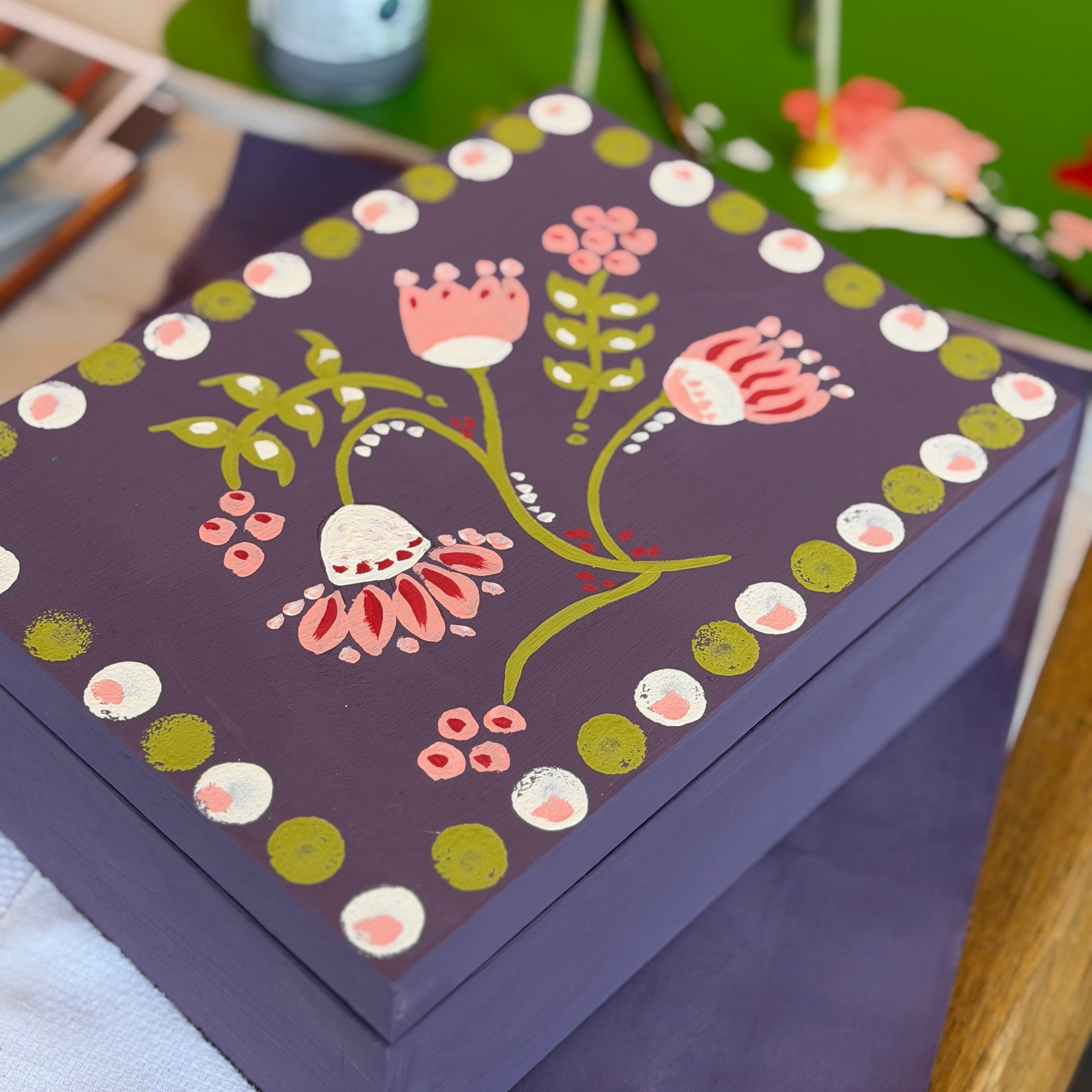 Decorative box with floral design on a table