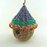 Bird nester in grass and sari fabric, pod shape