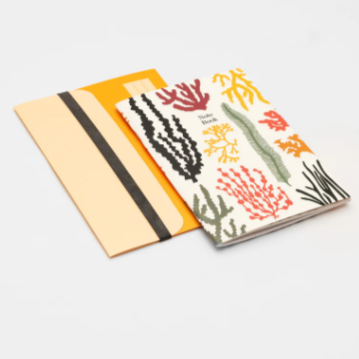 Two notebooks with coral reef designs on a white background